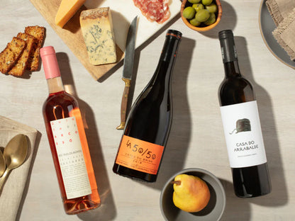 Plonk Mixed Wine Club with various bottles on wines, cheese, fruit, olives and crackers on a table image